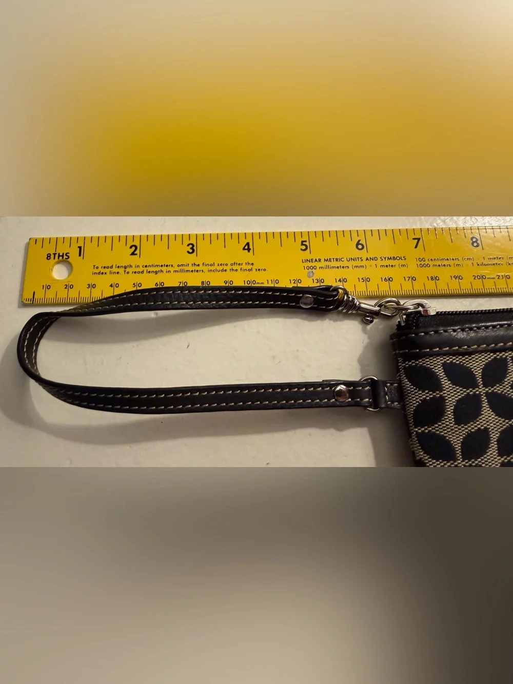 Fossil monogram canvas wristlet/wallet with leather trim.